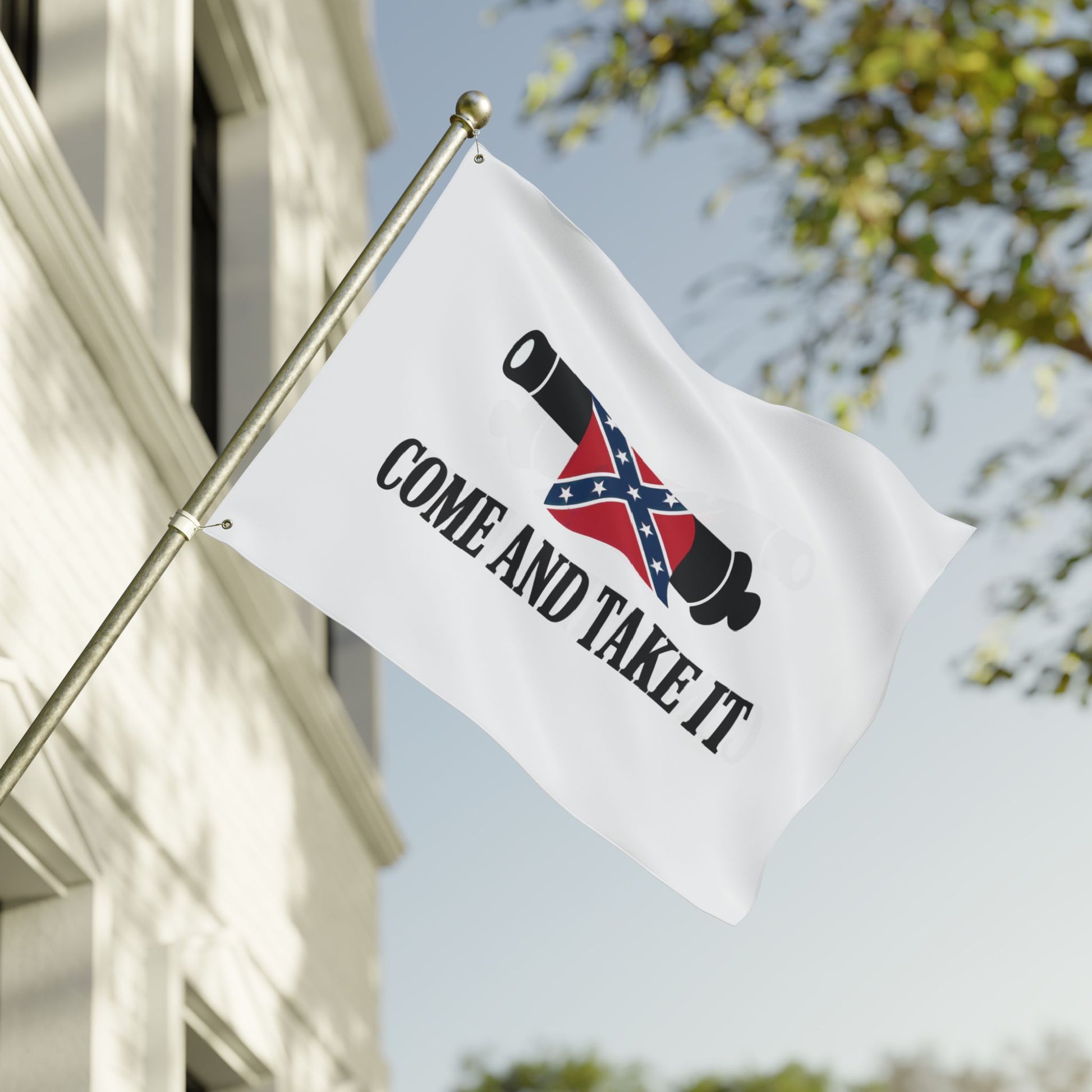 Confederate Come and Take It flag with cannon graphic flying on flagpole outside a building