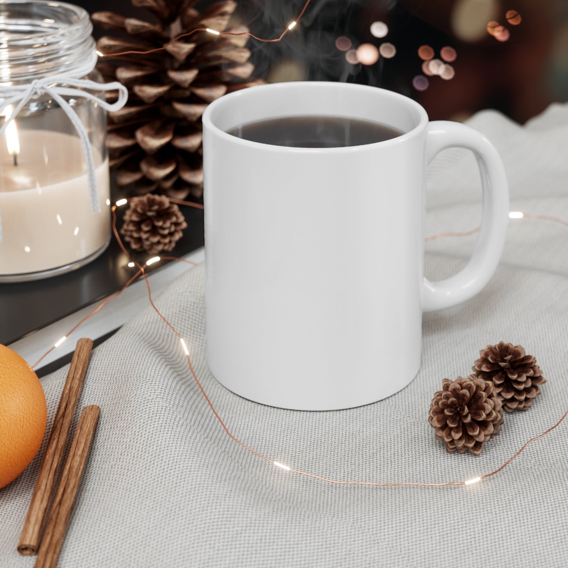 Plain white coffee mug on cozy surface with pinecones and candle nearby for Confederate flag coffee mug