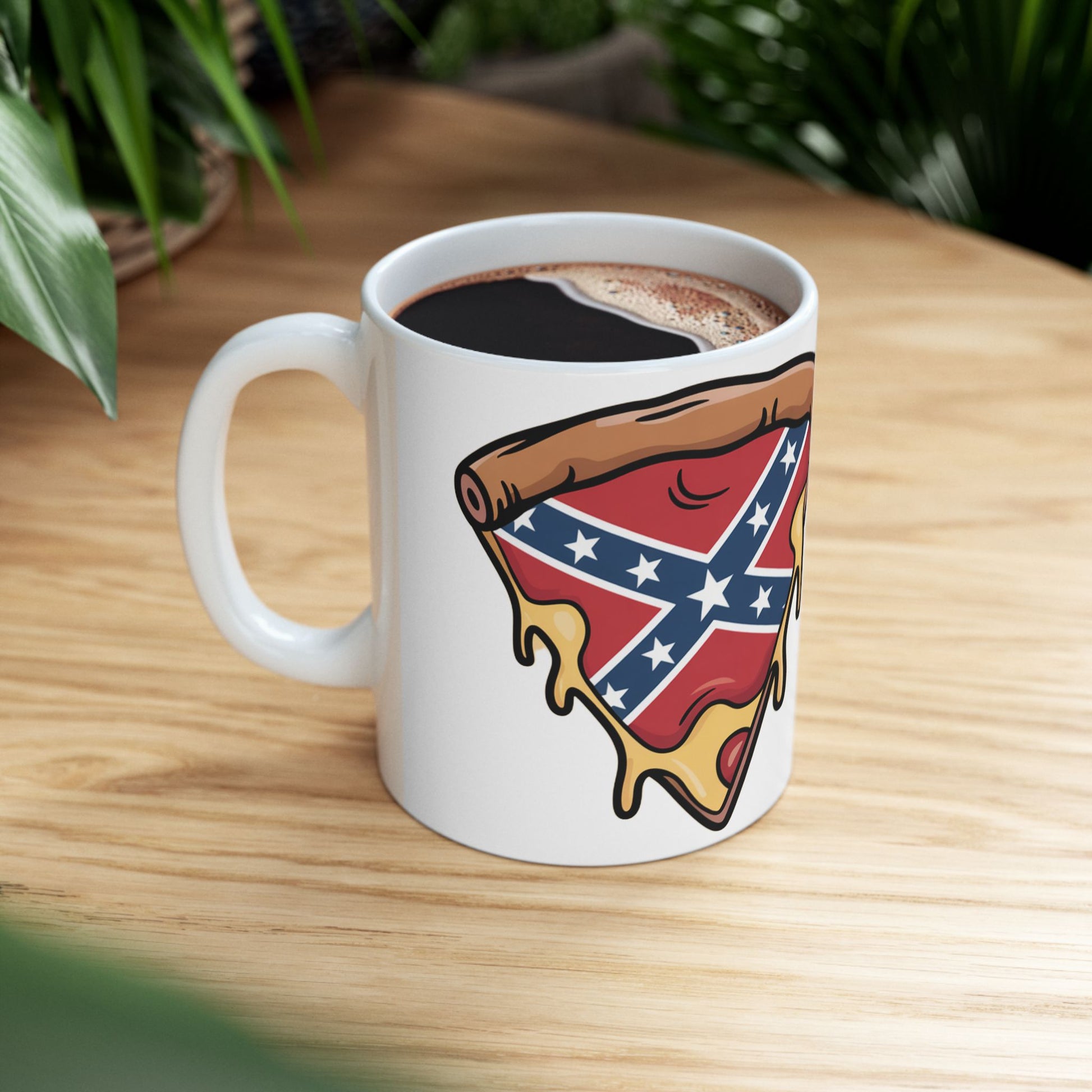 White mug featuring a slice of pizza with a Confederate flag design filled with coffee on a wooden surface