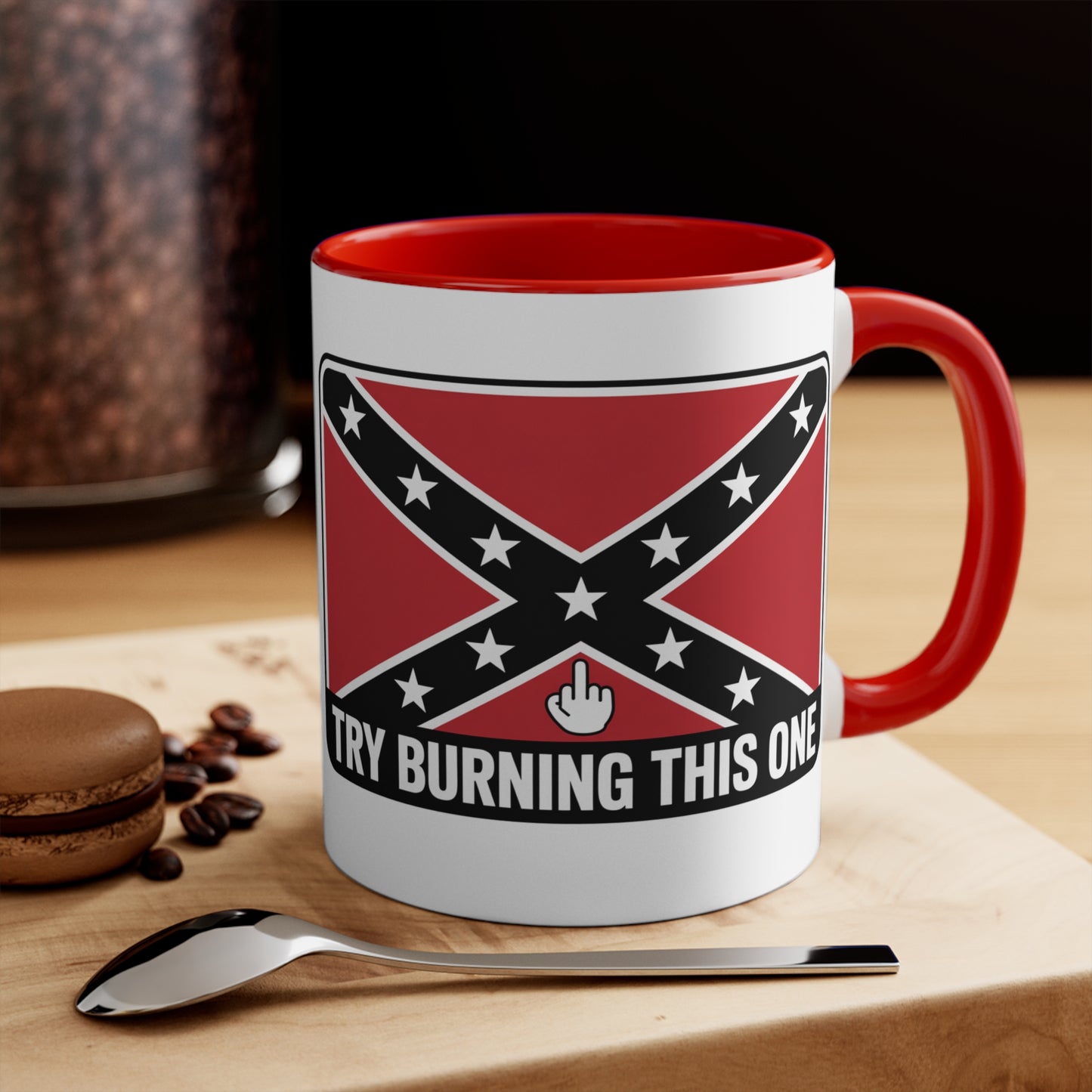 mug with Confederate flag mug design and red handle on wooden surface with spoon and macaron