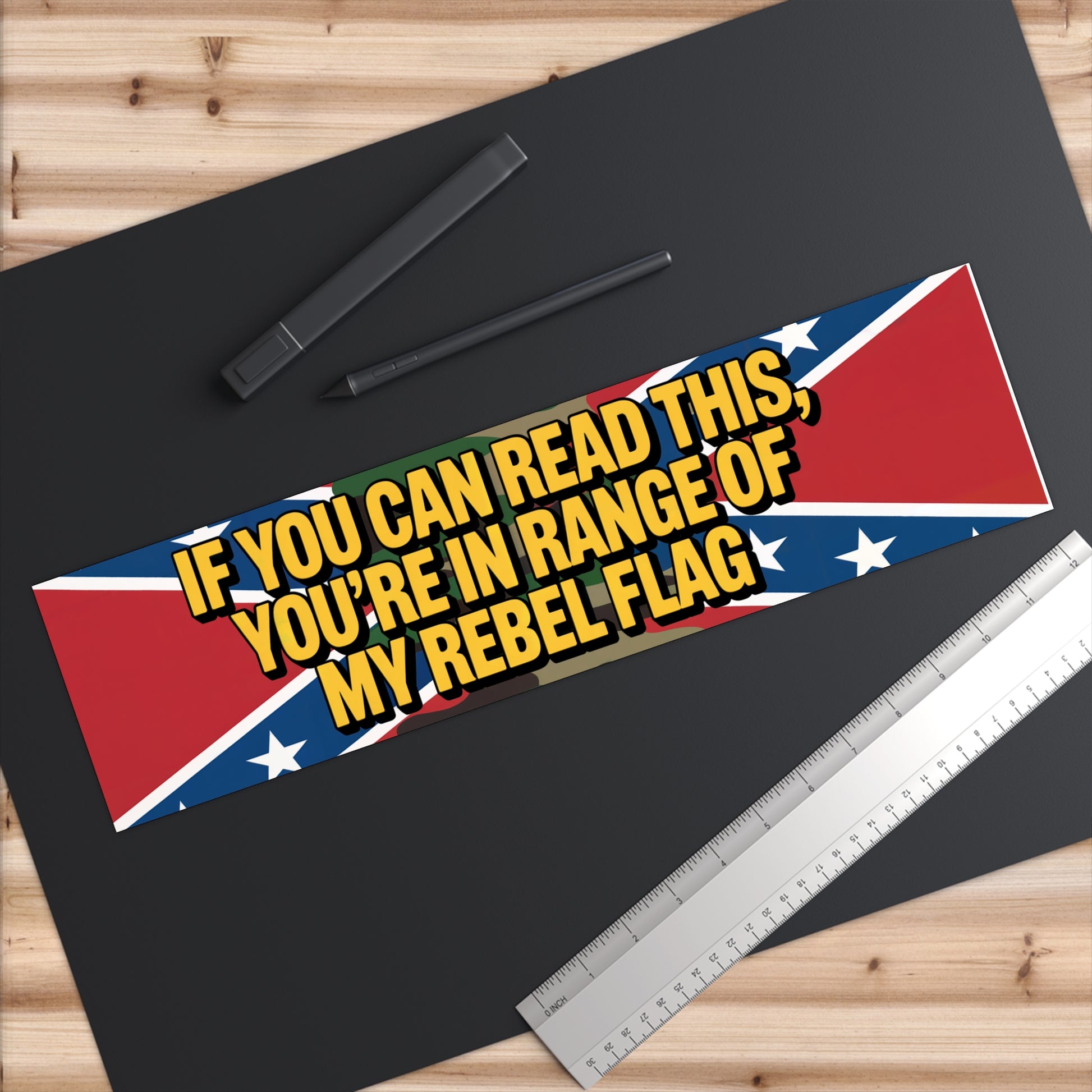 rebel flag bumper sticker with bold yellow text on Confederate flag background on a black surface
